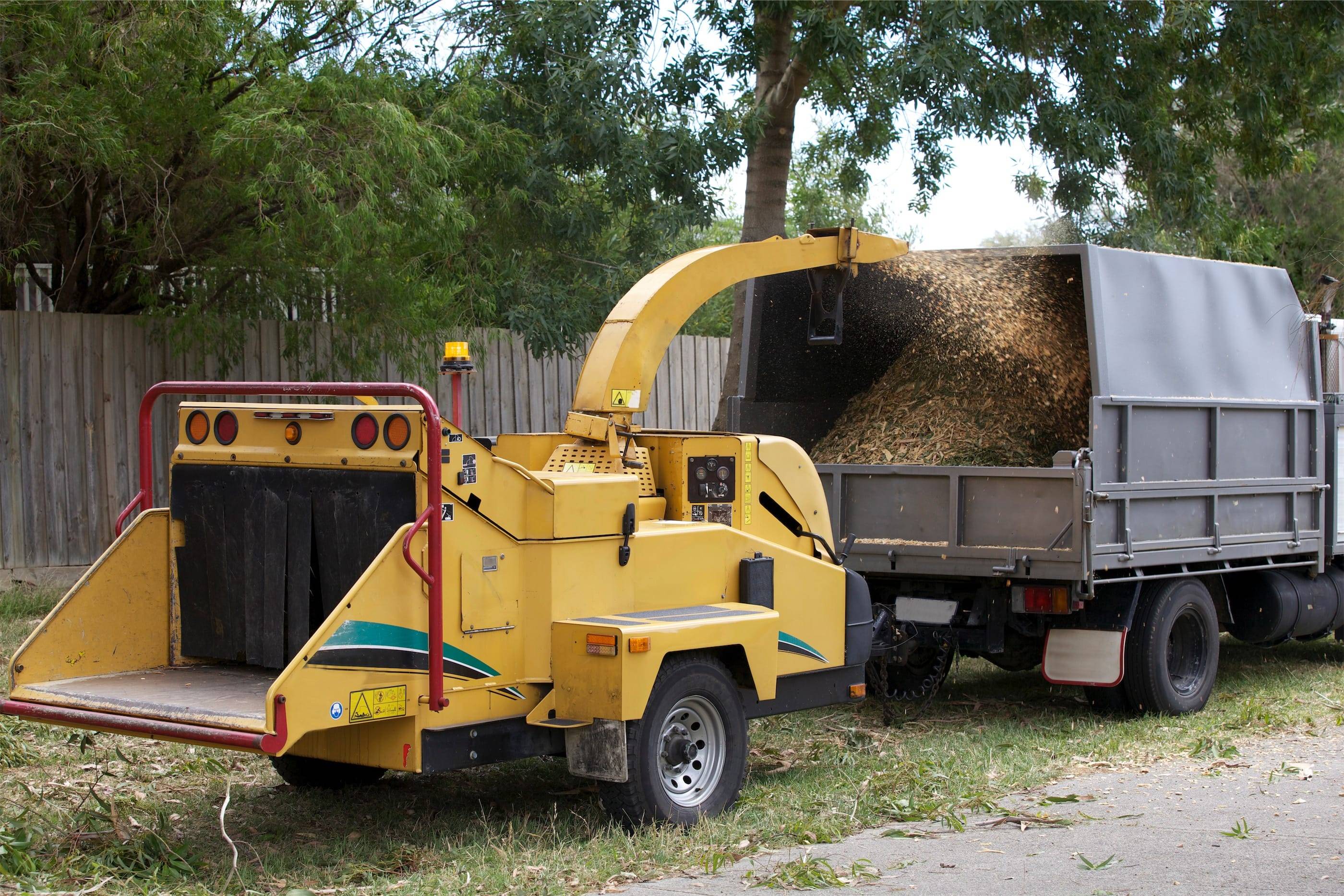 A truck with a chipper attached to it.