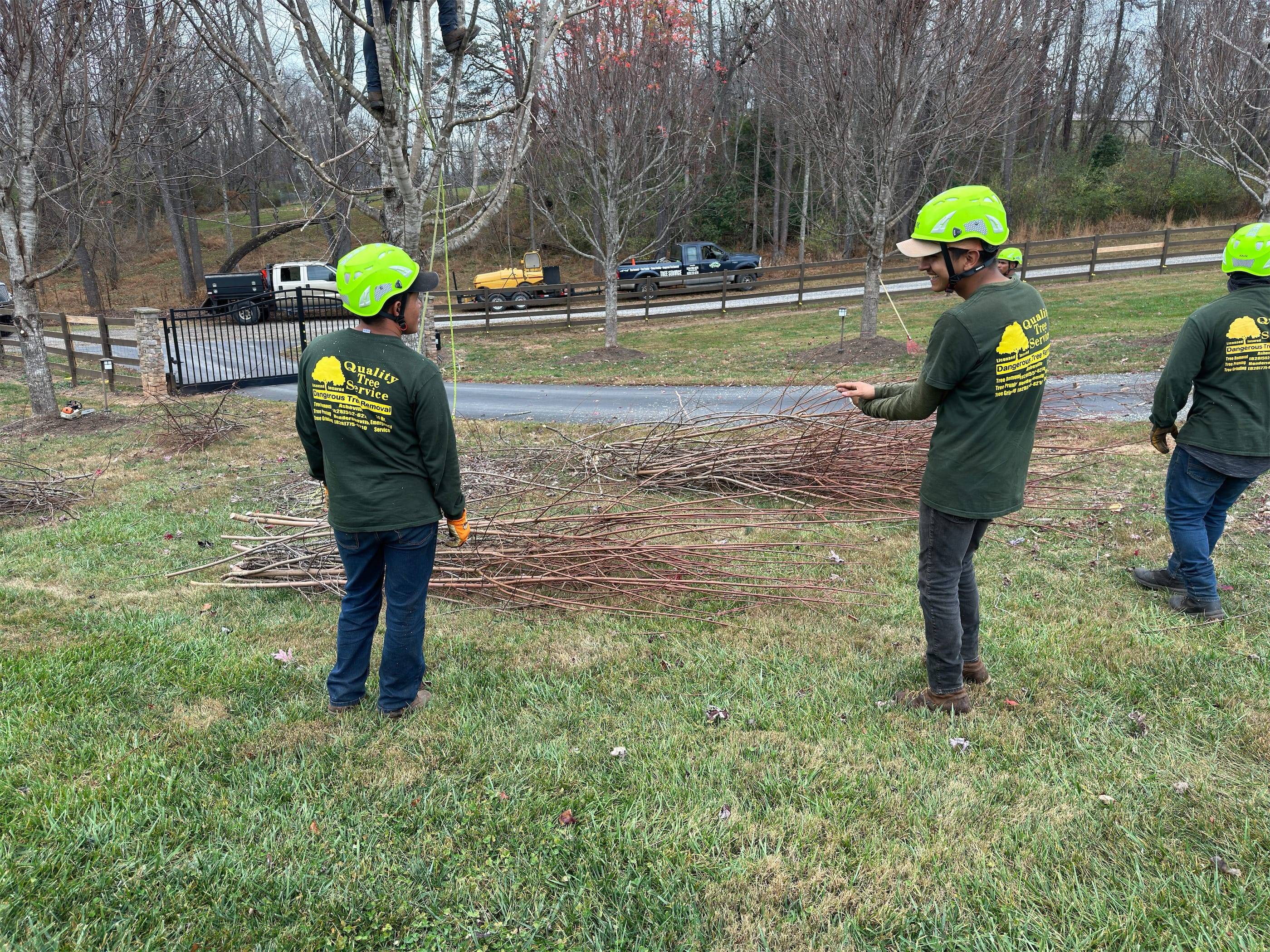 A group of men in hard hats standing in a grassy area.