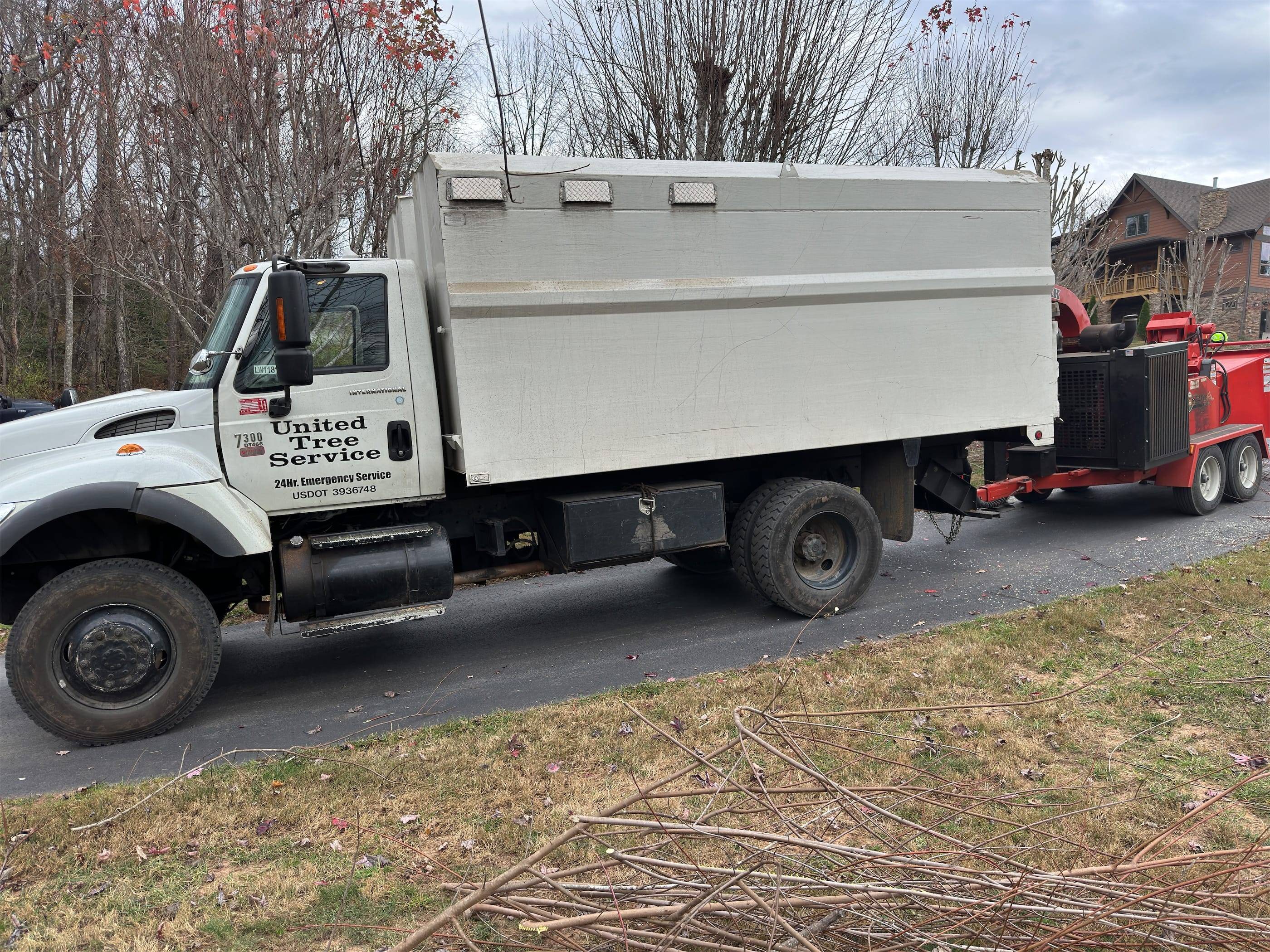 A white truck pulling a trailer.